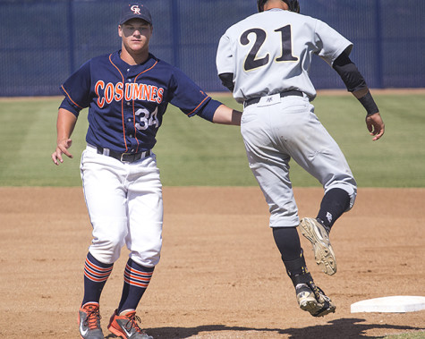 Cosumnes River College freshman first baseman Nathan Ahlers tags out San Joaquin Delta College freshman catcher Collin Theroux on his way to first base in the Hawks' home game on April 21. The Hawks won the game 1-0 and tied San Joaquin Delta College for first place in the Big 8 Conference.