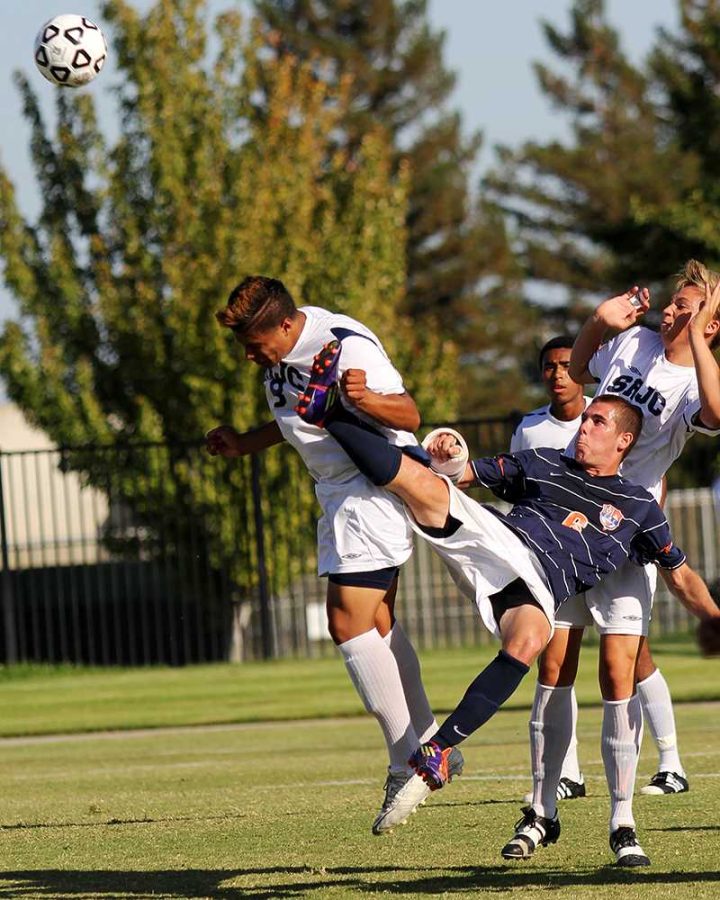 Freshman midfielder Ander Saez tries to keep the ball away from a group of Santa Rosa Junior College defenders in the Hawks' Sept. 25 home game. Through the first half of the game, the Hawks drove the ball into SRJC territory but could not capitalize with a goal. 