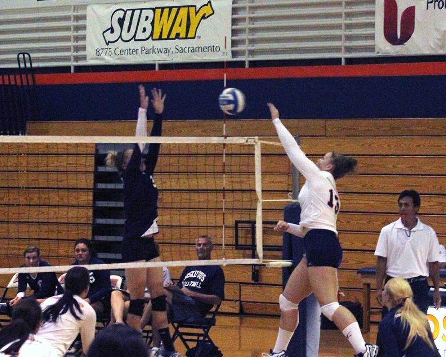 Freshman opposite Jennifer Lysaght spikes the ball against College of the Siskiyous in the first game of the Cosumnes River College Three-way Mini-tourney on Sept. 13. The Hawks fell to second place in the third match after losing to De Anza College.