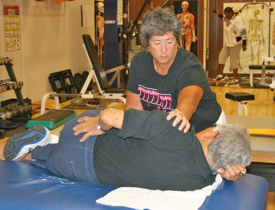 Jeanne Calamar assists Sam Seaikawa, 79, with an exercise during her adapted physical education class on Sept. 27. 