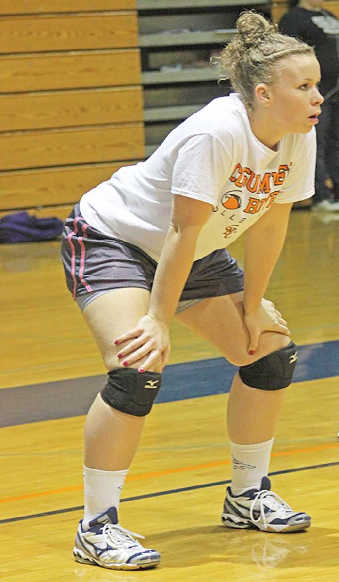 Freshman opposite hitter Jenny Lysaght looks on while she practices with her teammates in the gym on Oct. 21. 