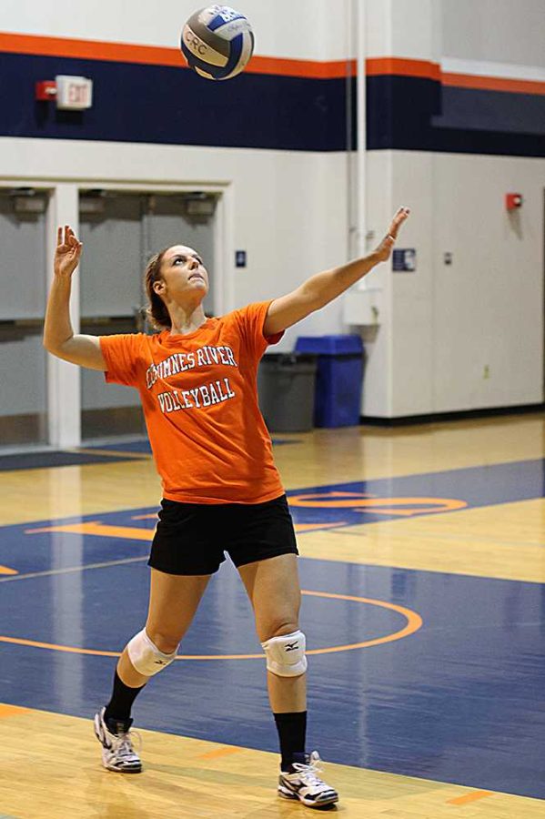 Sophomore setter and opposite hitter Laura Villano practices serving in a team practice scrimmage on Oct. 1. Villano plays for both the volleyball and softball teams at Cosumnes River College.
