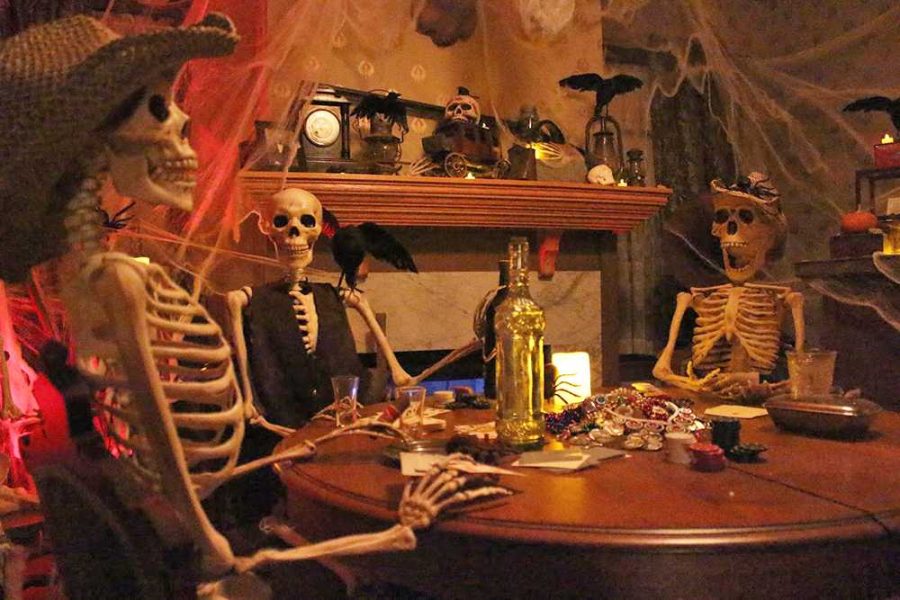 Prop skeletons sit around a table in a hauntingly decorated room at the Elk Grove Historical Society's new haunted house. This October marks the Historical Society's first invitation to their haunted experience. 