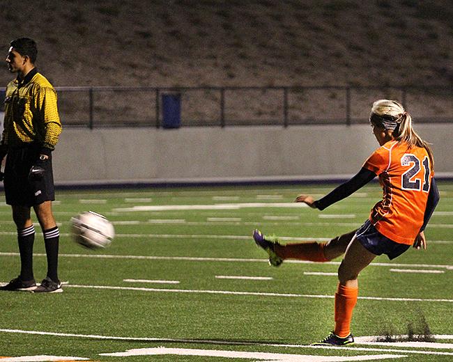 Sophomore midfielder Kaylyn Toyama takes a free kick and sends the ball sailing into the top-right corner of the goal in Cosumnes River Colleges playoff game against Santa Rosa Junior College on Nov. 26. Toyamas goal was the only goal scored in the game.