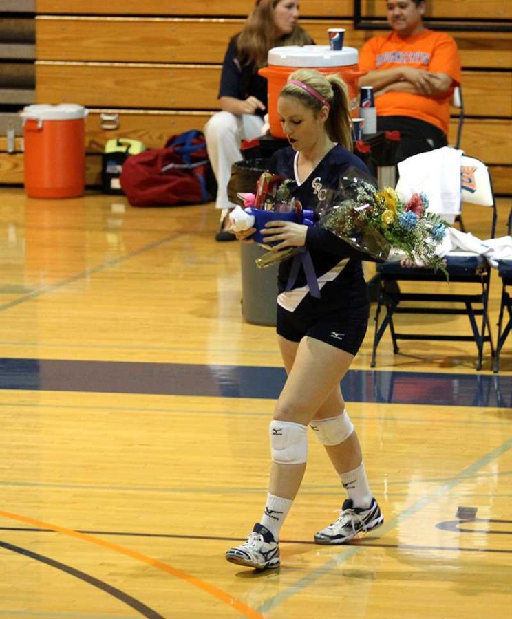 Sophomore outside hitter Laura Villano receives a bouquet of flowers, along with all the other sophomores, as part of the Sophomore Night festivities before the volleyball teams game against Modesto on Nov. 20.