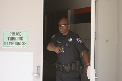 An officer, armed with a dummy firearm, leaves the scene of the active shooter training in May 2010.