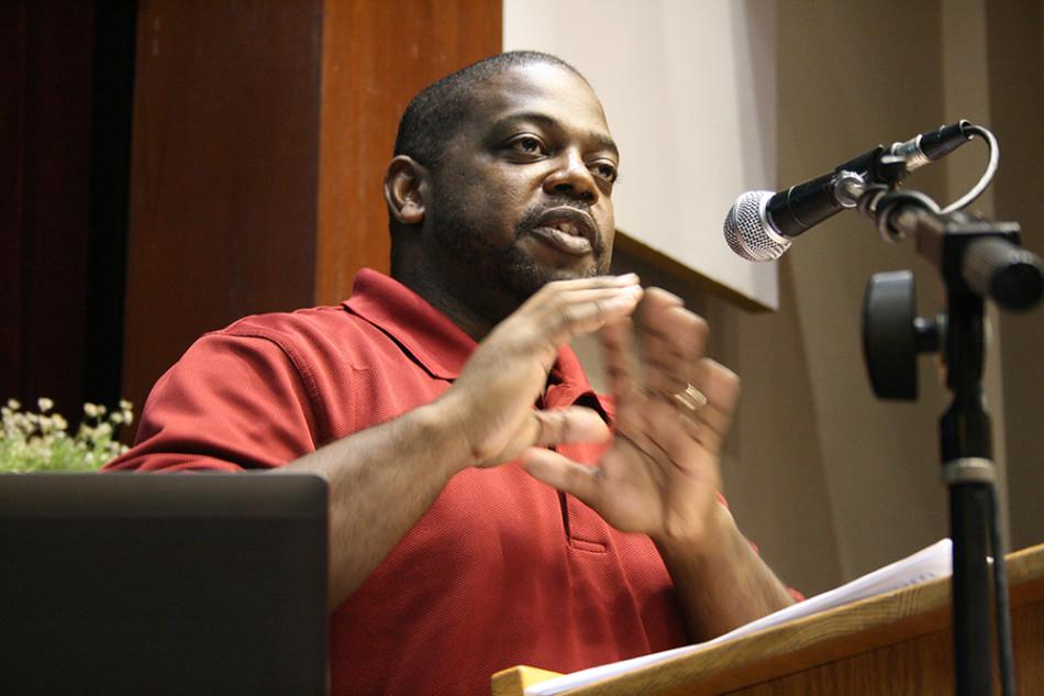 Sean King, a poet who performed at the Cosumnes River College Black History Month event Poetic Voices, reads one of his works to students and faculty in attendance.  King was one of three professional poets at the event held Feb. 19.