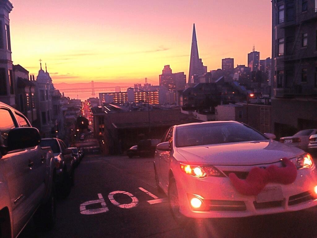 LYFT%27s+vehicles+are+marked+by+their+distinctive+pink+mustaches+on+the+hood.++LYFT+offers+the+ability+to+call+for+rides+through+an+app+as+well+as+the+ability+for+students+and+others+to+become+employed+as+drivers.+