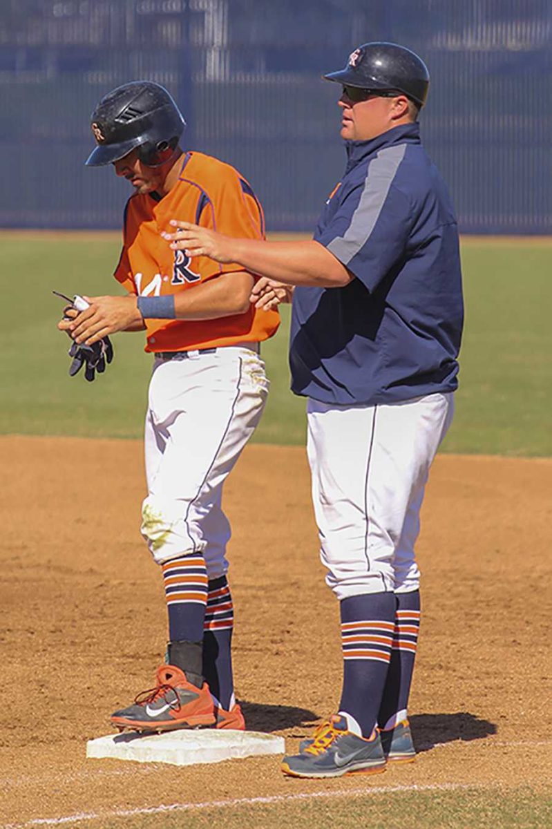 Former Oakland Athletic and Sacramento Rivercat Brad Kilby (Right) coaches a Cosumnes River College Hawks player during a game on March 20.