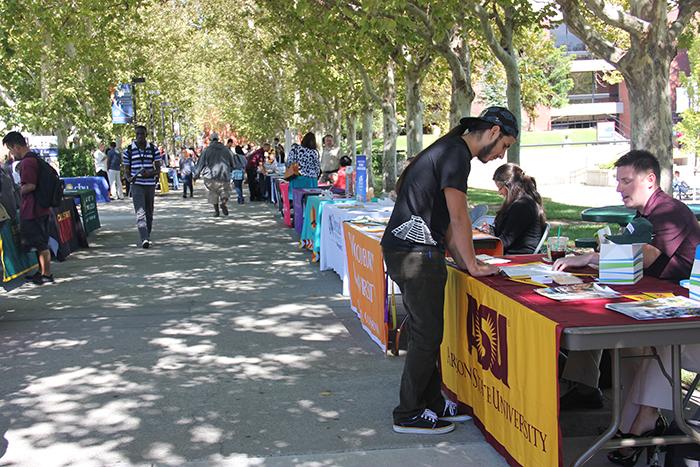 Students who attend Cosumnes River College visit the tables set up by various four-year colleges in preparation for transfer at the fall Transfer Day Fair in September 2013. Attending a two-year college similar to CRC gives students a leg up educationally and financially when they transfer to the next level of education.