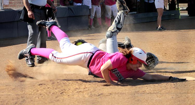 Sophomore outfielder Jessica Venturelli, in her pink uniform for the days breast cancer awareness drive, dives for home base in an attempt to tie the score against the American River College Beavers sophomore catcher Jordyn Bradley on April 19. Venturelli was called out, and the Hawks lost the second game of their double header against ARC, 5-4. 