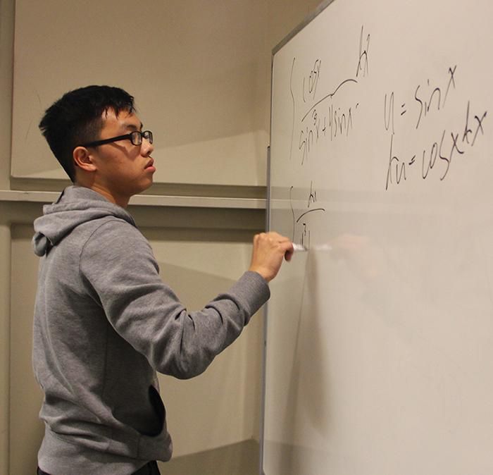 Yi Lor, 22, a biology major solves a complex integral in the first round of the competition. 
