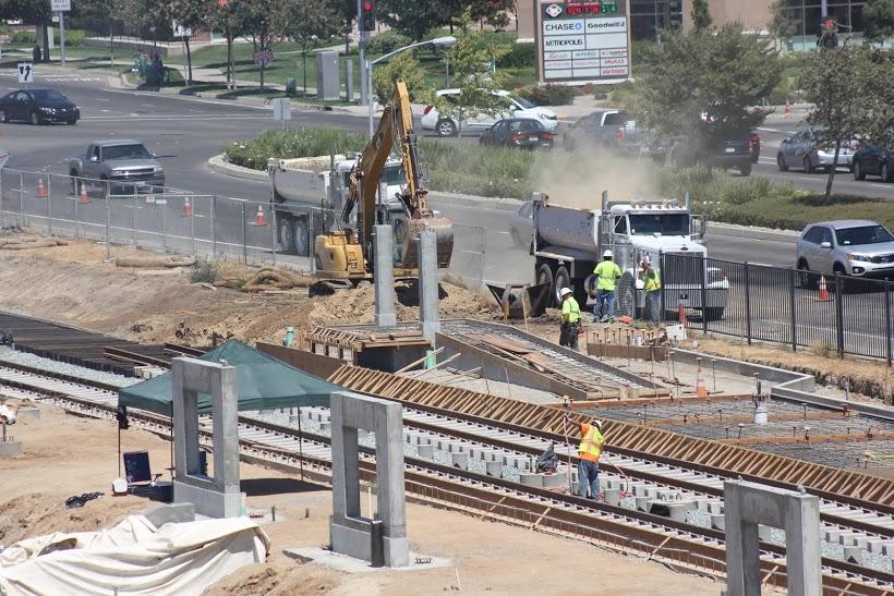 Construction workers expand the Blue Line Light Rail near CRC's Bruceville Road entrance. Work on the line is scheduled to be completed in September 2015.