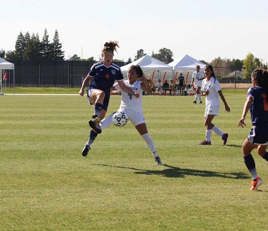 CRC Hawks freshman midfielder Kate Burkhardt leaps into the air for the ball, connecting with an opposing player from Evergreen Valley College Hawks.  Burkhardt and her team defeated the EVC Hawks 4-3 but the close game underscores the rough season start for the team. 