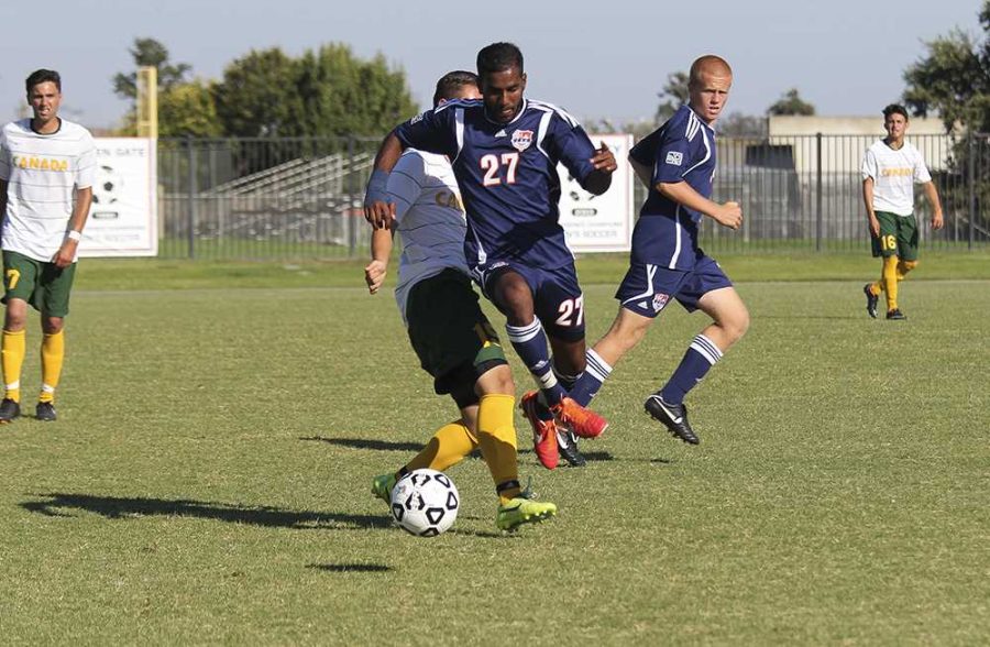 Sharukh Ali, freshman midfielder for the Hawks, leaps past Canada Colts freshman midfielder Omar Ramirez for the ball during the Hawks dominating field performance on Sept. 12. The Hawks defeated the Colts 3-0, securing their second win for the season. 