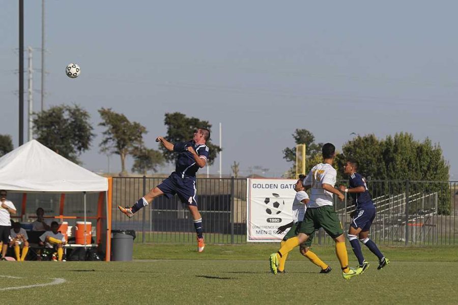 Hawks sophomore defender Brad Burkhart leaps to intercept the incoming ball. Burkhart is one of only four sophomores on the mostly freshman team.