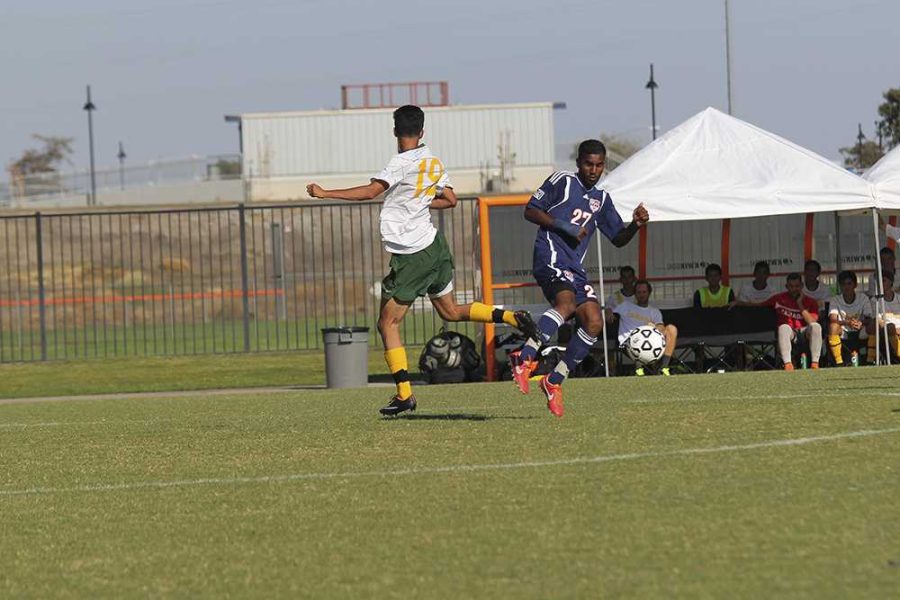 Midfielder Sharukh Ali slides past Canada freshman midfielder Omar Ramirez during the Sept. 12 match.