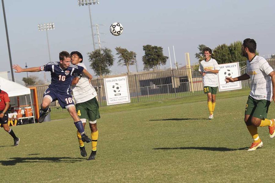 Surrounded by opposing players, Hawks freshman midfielder Tyler Mickey blows past Canada sophomore defender Marco Amarilles with his sights set on the ball.