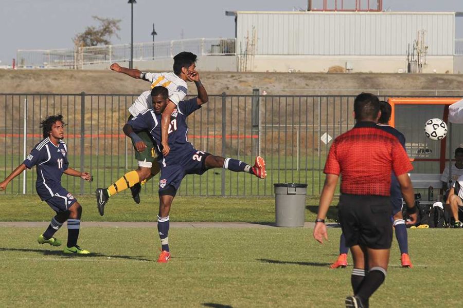 Ali ends up tangled in mid-air with Canada freshman forward Kevin Amaya.