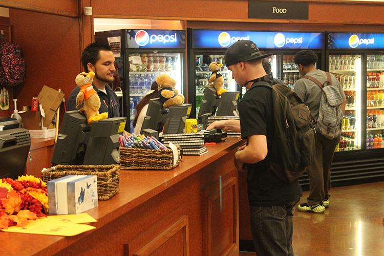 Students spending money and browsing in the campus book store.