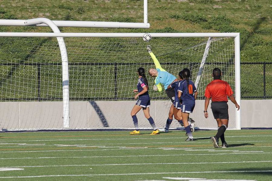 Sophomore goalkeeper Anna Brown leaps high to block one of the many attempted goals from the Taft College Cougars.