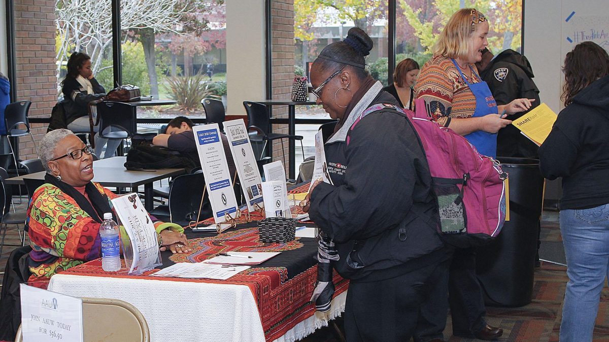 SHAREfairs+vendors+took+over+the+cafeteria+on+Nov.+19+to+talk+to+students+and+receive+donations.