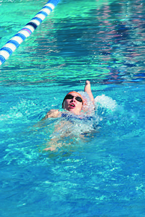 A swimmer for Cosumnes River College’s women’s team diving into the pool during their team relay at the Big 8 Invitational at American River College on March 13.