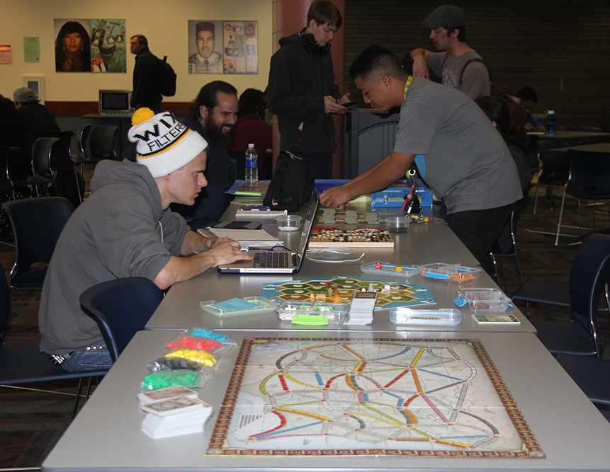 Members of the Kingdom Builders including founder and President Richard Spark, pictured second on right, meet in the cafeteria on Thursdays to play various strategy games like Settlers of Catan and Ticket to Ride.