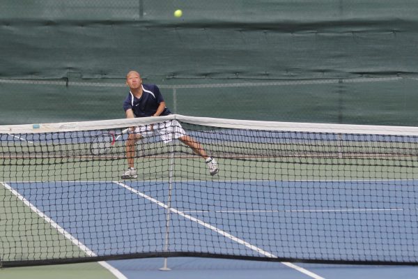 Freshman player Ricky Lam  playing a singles match against Sacramento City College on March  10.