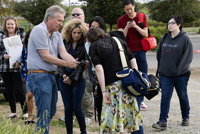 Photography professor Jim West (left) shows his Advance Portrait students an image captured on his camera during a small trip across the street from CRC on March 23. 