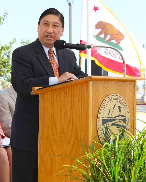 Interim President Whitney Yamamura speaks to faculty members and guests at the dedication of the Elk Grove Center in August 2013. As Vice President of Instruction and Student Learning, Yamamura played a key role in the formation of the center.