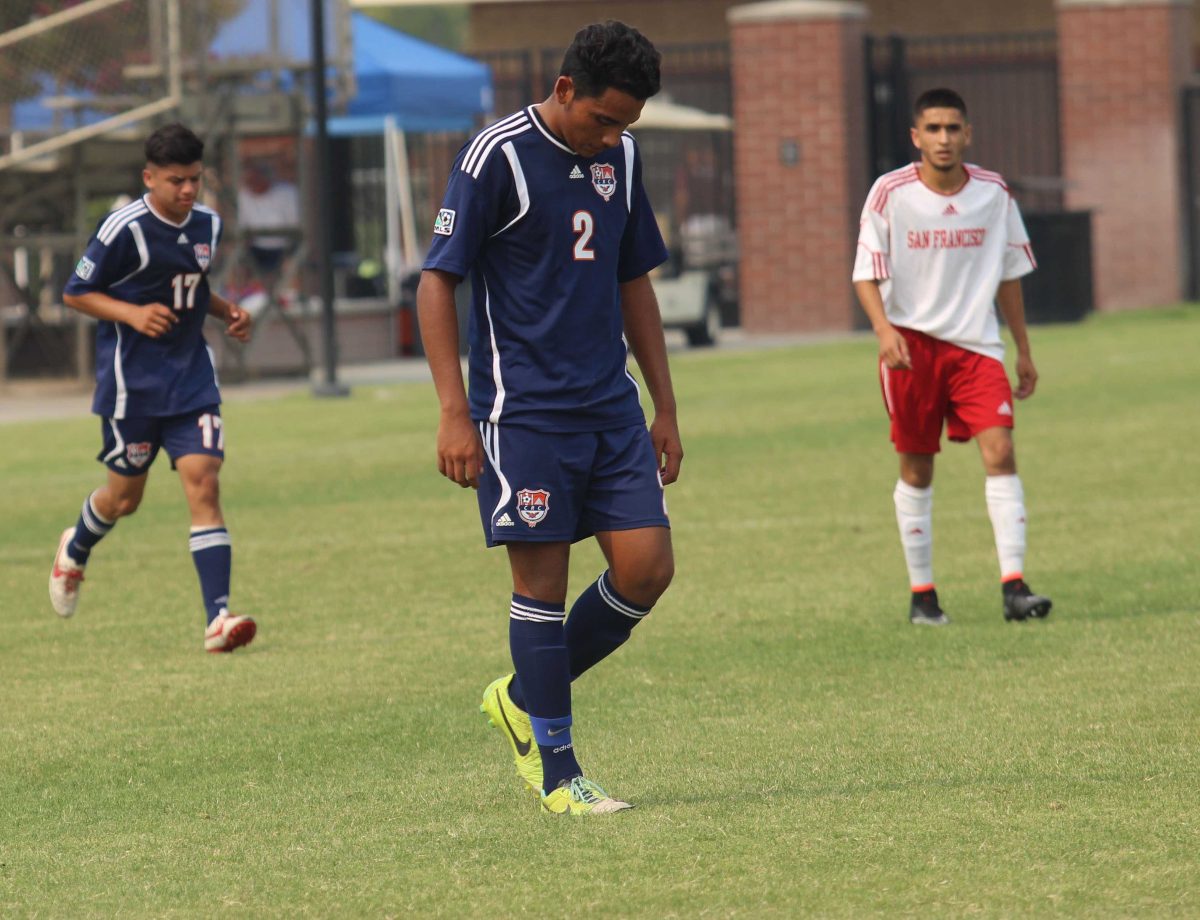 Defender Jose Alvarez walks, center, across the field with teammate  midfielder Juan Ramirez following a 3-1 loss to San Francisco City College on Sept. 13. The Hawks went on to struggle the rest of the season only earning two wins out of the 20 games they played. Head Coach Ron Preble said that a lack of experience among the team led to the disapointing season.