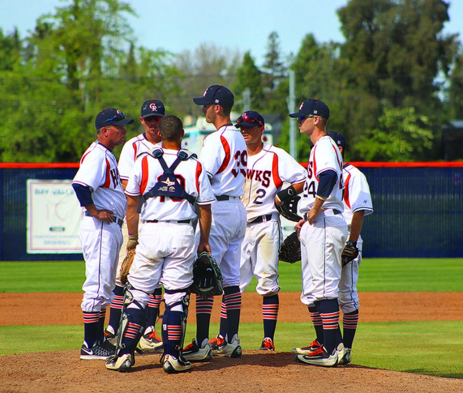 Hawks infielders have a mound visit with head coach Tony Bloomfield on March 26 against Diablo Valley College.