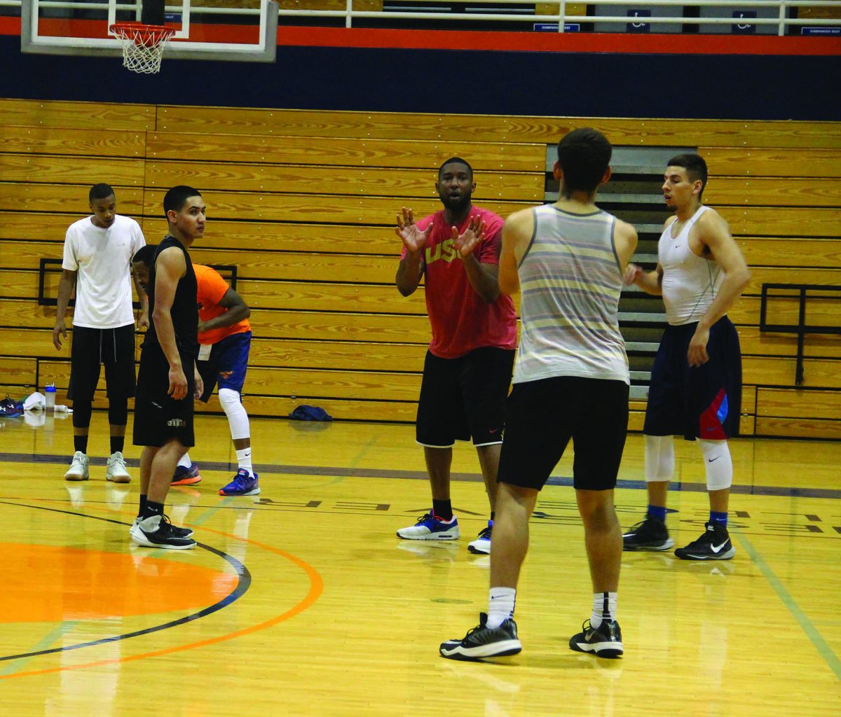 Men's basketball coach Jonathan James takes part in an evening practice session.