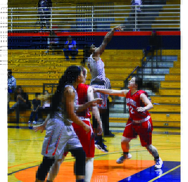 Freshman forward QuoQuese Jackson (top) attempts a jump shot against College of Siskiyous on Monday.