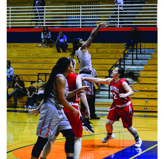 Freshman forward QuoQuese Jackson (top) attempts a jump shot against College of Siskiyous on Monday.