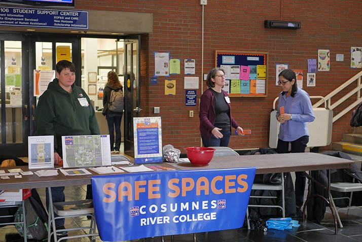 Safe Spaces Day coordinator Anastasia Panagakos (center) and faculty allies raise awareness for the Safe Spaces Program on Tuesday. 