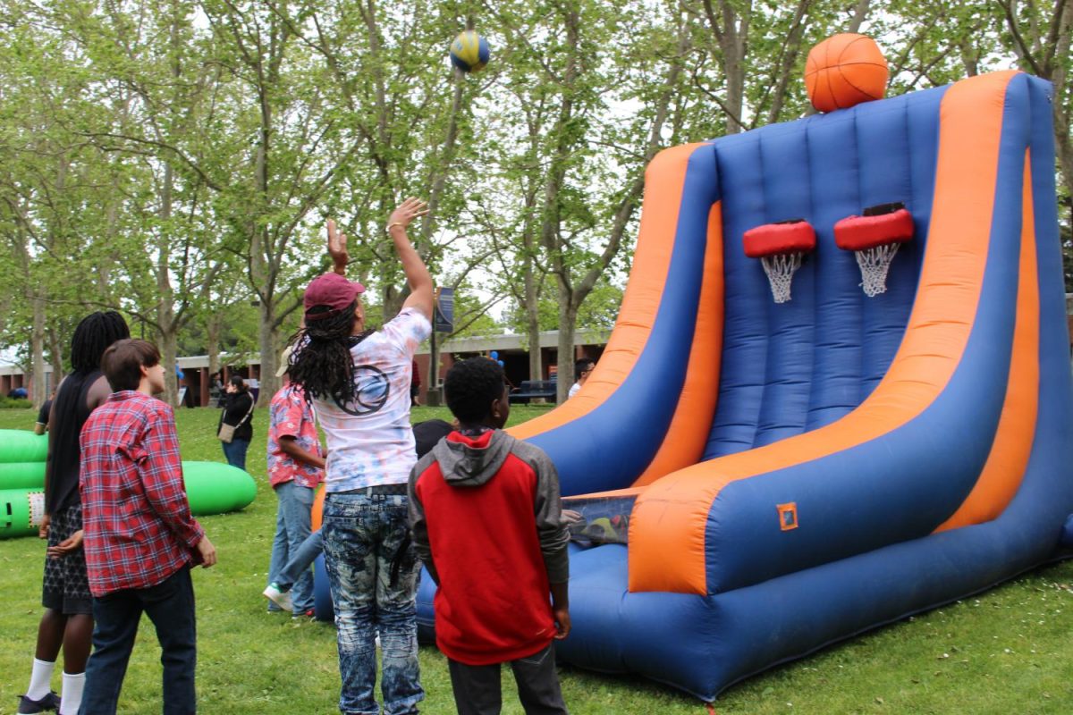 Students participated in different activities, such as playing inflatable basketball hoop.