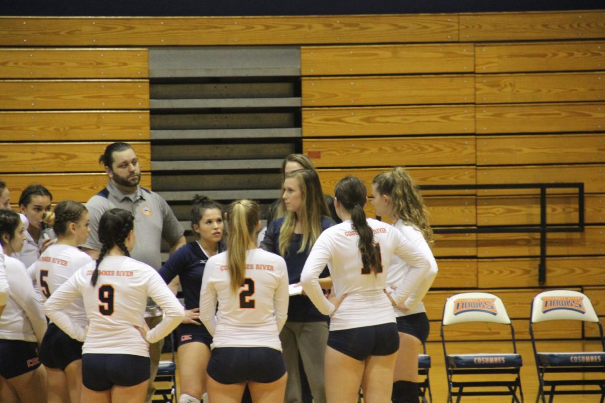 Volleyball head coach Kari Post huddles with her team during the Hawks game against Modesto on Sept. 15.