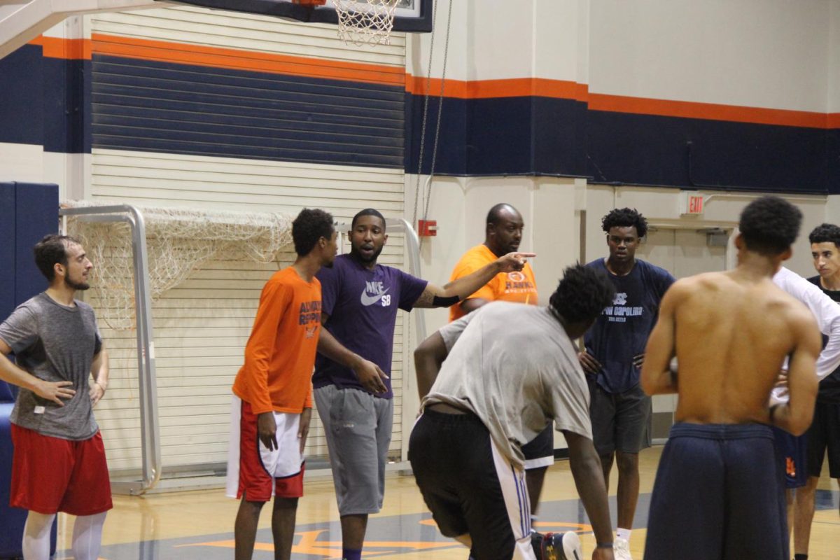 Mens+basketball+head+coach+Jonathan+James+runs+the+new+team+through+drills.