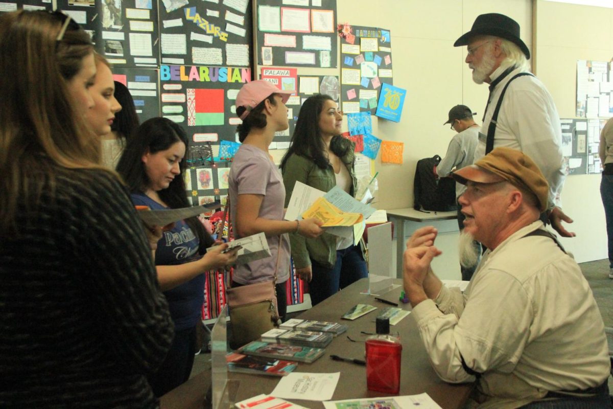 Students gather at The Sacramento History Museum's table to learn about Sacramento's past at the Anthropology Expo at Cosumnes River College on Oct. 27. 
