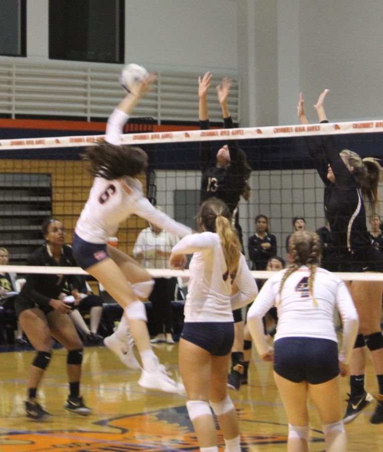 Hawks sophomore middle blocker Meg Maddalena goes for the point in Friday's game against the San Joaquin Delta Mustangs.