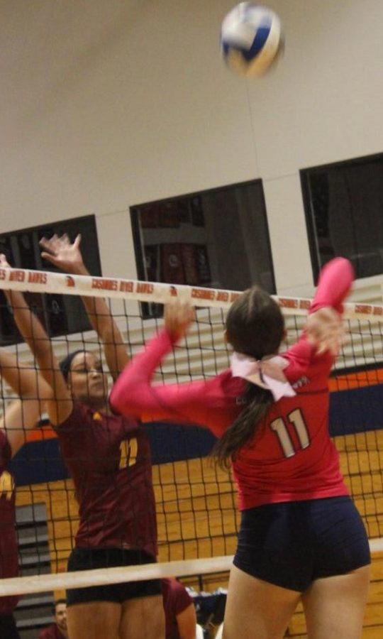 Freshman middle blocker Destinee Elliott goes for the spike against Sacramento City on Oct. 11. Elliott has scored 87 points so far this season.