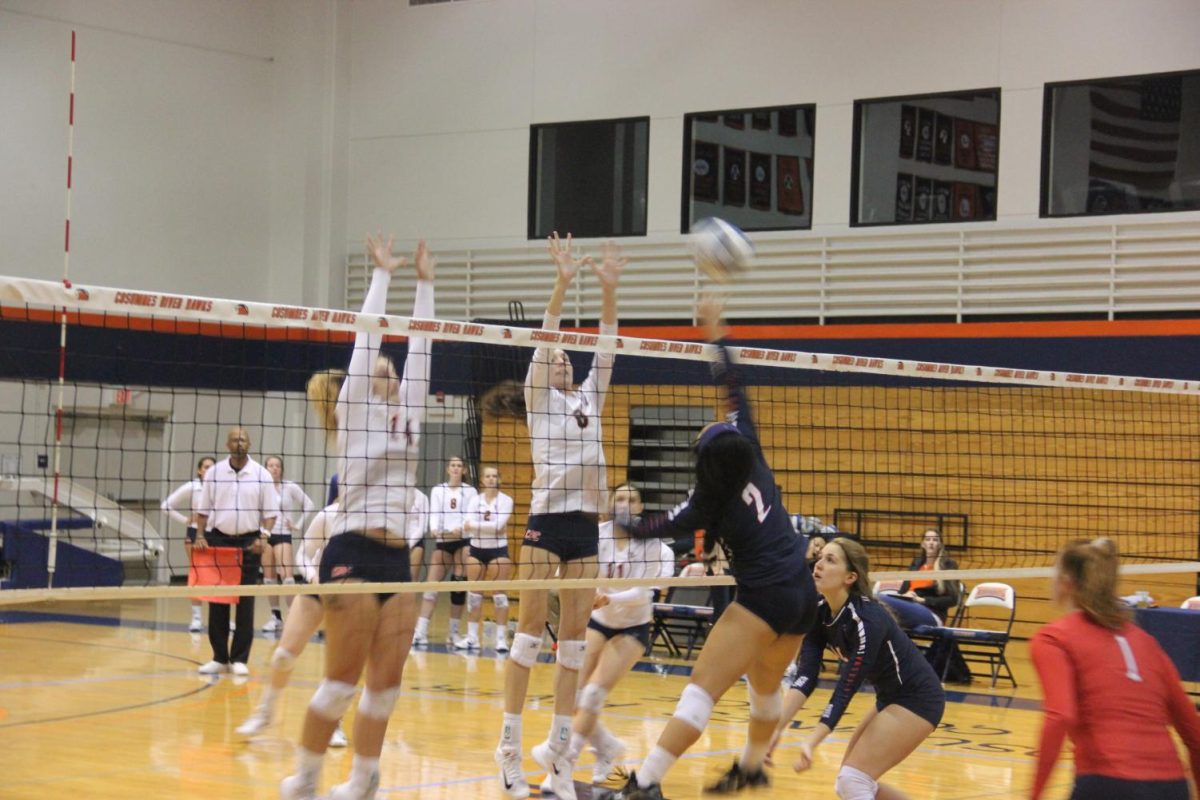 Outside Hitter Rebakkah McLaughlin (left) and Opposite Jade Griley block against the Beavers on Nov. 3.