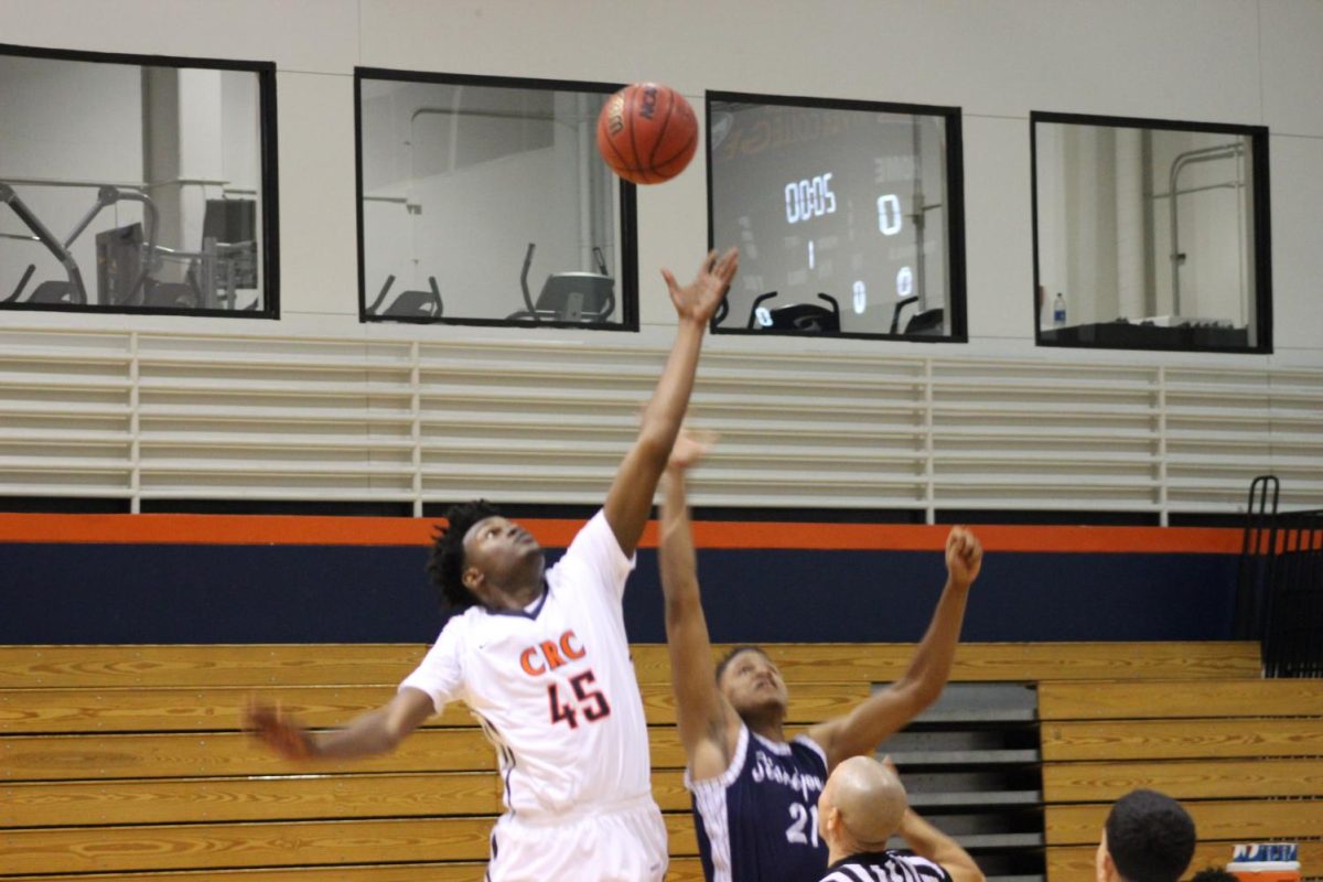 Sophomore forward Everton Maxwell participates in the tip off to start the Hawks' tournament run on Nov. 30.