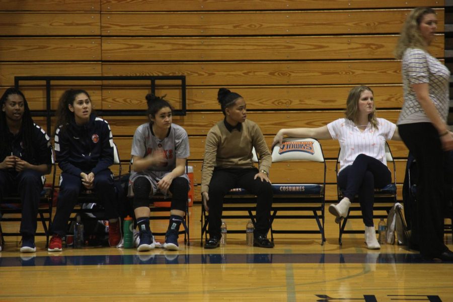 Assistant coach Jasmine Chapman, center, looking on as the Hawks play against Sierra College on Jan. 16. Chapman promoted as the new assistant coach under head coach Coral Sage.