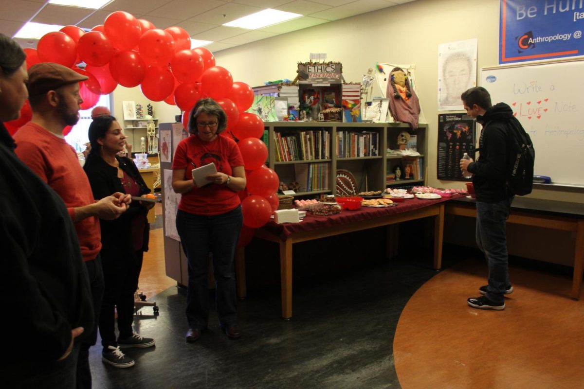 In room LRC-103 Anthropology professor Anastasia Panagakos, middle, is writing her love note for the event on Feb. 14. for "Anthro Day of Love." That the Department of Anthropology hosted for their students.