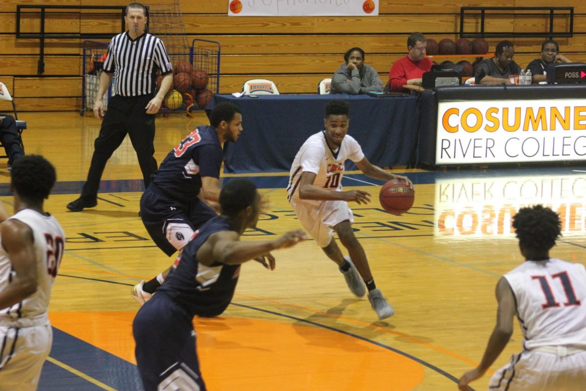 CRC sophomore guard Jordan Roberson passes through freshman Malcom Jenkins to attack the rim and score in the Big 8 matchup on Feb.9