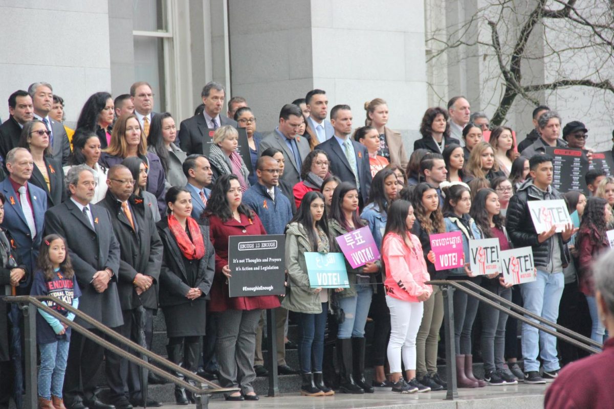 People stand in silence on the steps of the Capitol during National School Walkout.