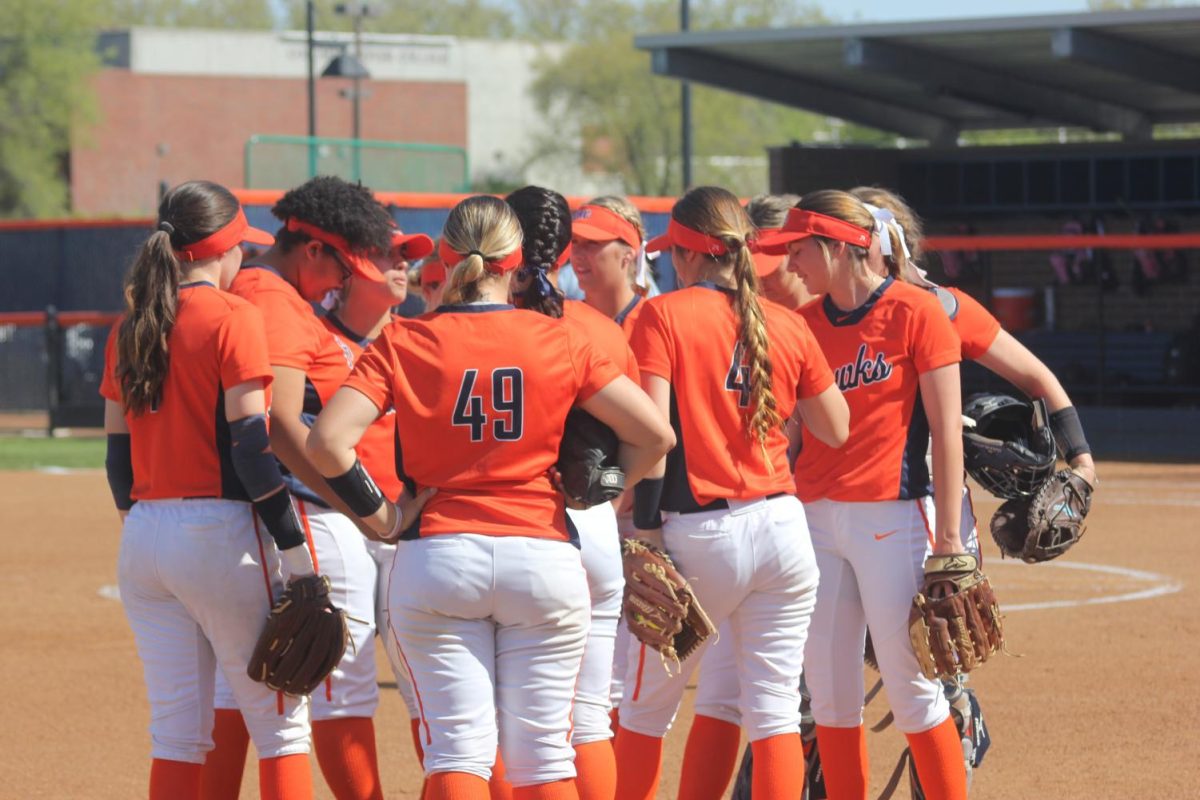 Hawks get together to discuss strategy ahead of the 2nd inning against Delta on April 3.